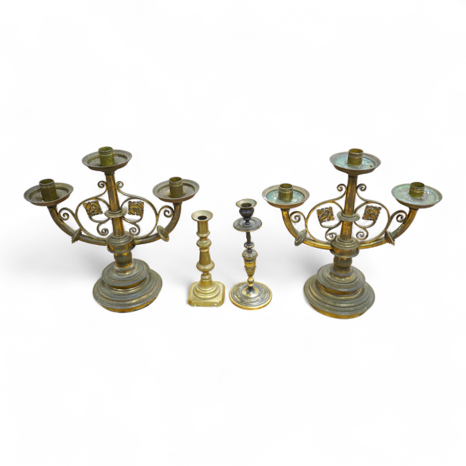 A pair of two brass branch, three light candelabra and two other brass candlesticks, largest 38cm high